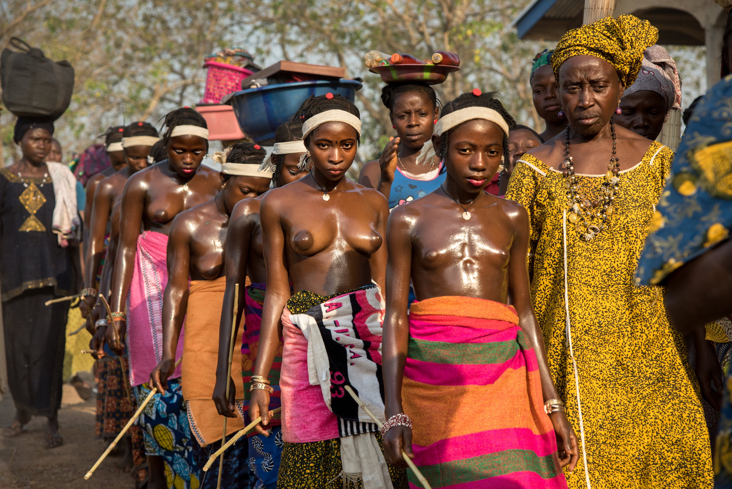Adolescent girls return from the bush at the conclusion of their initiation ceremony.